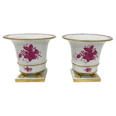 two white vases with pink flowers on them