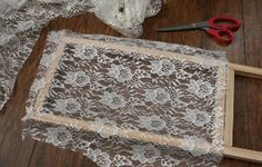 lace and scissors are laying on the floor next to a piece of cloth that has been cut