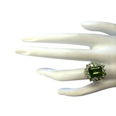 Stamped: 14K White GoldTotal Ring Weight: 6.5 GramsRing Length: N/ARing Width: N/AGemstone Weight: Total Natural Peridot Weight is 4.27 Carat (Measures: 11.06x8.87mm)Color: GreenDiamond Weight: Total Natural Diamond Weight is 0.70 CaratColor: F-G, Clarity: VS2-SI1Face Measures: 18.42x16.83 mmSku: [702688W] Art Deco Green Emerald Multi-stone Ring, Formal Peridot Diamond Ring With Center Stone, Antique Green Diamond Ring With Center Stone, Green Diamond Ring With Gemstone Accents For Formal Occasions, Formal Green Diamond Ring With Gemstone Accents, Formal Green Diamond Ring With Center Stone, Green Oval Diamond Ring Collectible, Formal Tsavorite Rings With Accent Stones, Formal Green Diamond Ring With Accent Stones