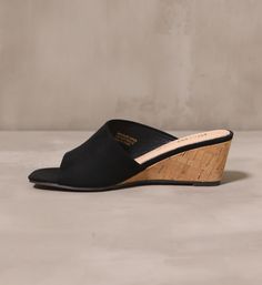 Getting closer everyday. A sleek silhouette by Mi.iM, these slip-on wedges are a versatile favorite. With a shallow heel and an open toe design, these heels can be pair with a sundress for a day look, or an LBD for a night out. Manmade Upper l Genuine Leather Insole l 2.5" Heel l True to Size Chic Wedge Sandals With Cushioned Footbed, Spring Platform Wedge Sandals With Low Heel, Spring Low Heel Platform Wedge Sandals, Chic Low Heel Wedge Sandals For Spring, Chic Synthetic Medium Width Wedge Sandals, Modern Wedge Sandals With Wooden Heel, Chic Synthetic Wedge Sandals With Wooden Heel, Trendy Wedge Sandals With Wooden Heel, Chic Low Heel Platform Wedge Sandals