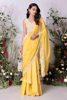 Yellow lehenga saree, accentuated with placement floral hand embroidery. Paired with a floral hand embroidered blouse.
Components: 2
Pattern: Hand Embroidery
Type Of Work: Floral, Beads, Sequins
Neckline: Deep V Neck
Sleeve Type: Sleeveless
Fabric: Satin Organza Blend, Viscose Organza
Color: Yellow
Other Details: 
Length:
Blouse: 14.5 inches
Lehenga Saree: 44.5 inches
Weight: 3 kgs
Attached inner lining
Note: The potli bag shown in the image is not for sale
Occasion: Sangeet - Aza Fashions Traditional Drape Slub Silk Dupatta For Reception, Traditional Slub Silk Dupatta For Reception, Navratri Draped Sets With Sheer Dupatta, Traditional Draped Wear With Resham Embroidery For Eid, Sleeveless Georgette Traditional Wear For Wedding, Designer Draped Traditional Wear With Resham Embroidery, Festive Draped Georgette Gown, Traditional Chanderi Draped Dupatta, Eid Draped Semi-stitched Lehenga