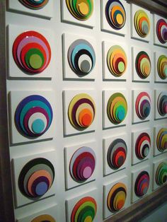 a wall with many different colored circles on it