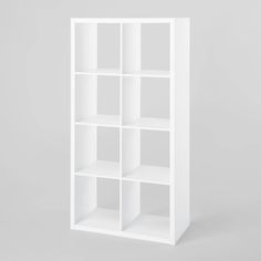 an empty white bookcase on a gray background