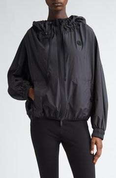 The Italian label known for its impeccable outerwear brings forth another layering staple with this lightweight windbreaker topped with a protective hood. Two-way front-zip closure Drawcord-toggle hood Elastic cuffs Front zip pockets Unlined 100% polyester Imported Designer Clothing Nylon Windbreaker With Detachable Hood In Athleisure Style, Athleisure Nylon Windbreaker With Detachable Hood, Black Athleisure Windbreaker With Detachable Hood, Athleisure Nylon Outerwear With Drawstring Hood, Black Nylon Hooded Jacket Athleisure, Black Nylon Athleisure Hooded Jacket, Black Nylon Windbreaker With Functional Drawstring, Sporty Nylon Hooded Jacket With Functional Drawstring, Nylon Hiking Outerwear With Functional Drawstring