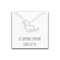 Super Cute Brontosaurus necklace plated in 18K silver. Great original gift for a dinosaur lover.QUALITY GUARANTEE. Strong necklace: if it breaks within three years we offer free replacement. Nickel free and hypoallergenic.Necklace Chain Length: Adjustable 18 to 15 inches - Pendant dimensions: 24.8mm x 16.5mm (.96in. x .65in.)Packaged with a sturdy message card that says “Be Someone Everyone Looks Up To.”Perfect for yourself or as a gift for your wife, daughter, girlfriend, bff, child/kid, or any Cute Brontosaurus, Dinosaur Brontosaurus, Hypoallergenic Necklace, Dinosaur Necklace, Who You Love, Necklace Cute, A Dinosaur, Quote Cards, Necklace Chain Lengths