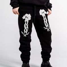 Unisex "Jogger" Style Sweatpants from Forbidden Alchemy. Designed for both comfort and style, these slim-fitting joggers feature a tapered ankle for a sleek silhouette that flatters all body types. Crafted from a premium blend of 80% cotton and 20% polyester, they offer the perfect balance of softness and durability, ensuring all-day comfort and long-lasting wear. Slim Fit: Tailored to hug your body while allowing ease of movement. Tapered Ankle: Provides a modern, streamlined look. Premium Fabr Relaxed Fit Hip Hop Pants For Jogging, Hip Hop Tapered Leg Sweatpants For Streetwear, Hip Hop Style Tapered Leg Sweatpants For Streetwear, Casual Fitted Joggers For Streetwear, Fitted Casual Joggers For Streetwear, Fitted Cotton Joggers For Streetwear, Baggy Pants With Comfort Waistband For Streetwear, Fitted Athleisure Sweatpants For Streetwear, Fitted Hip Hop Pants For Streetwear