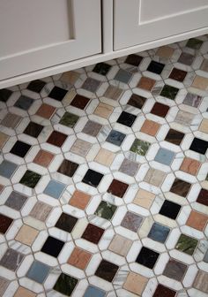 an image of a kitchen floor that looks like it has many different colored tiles on it