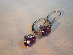 Use coupon SALE18 for 18% off all merchandise. These genuine African AAA Amethyst dangle drop lever-back or stud earrings have beautiful AAA colors in purple/mauve color tones. The natural mined Checkerboard cut oval 8x6mm size is approximately 2.50 total carat weight in the pair. The clarity is VVS excellent eye clean. The color is outstanding and the faceting creates beautiful sparkle. The gemstones are guaranteed genuine natural earth mined quality AAA VVS clear Zambia, Africa Amethysts. *set Zambia Africa, Purple Mauve, Color Tones, Mauve Color, Amethyst Earrings, Natural Earth, Zambia, Amethyst Stone, Purple Amethyst