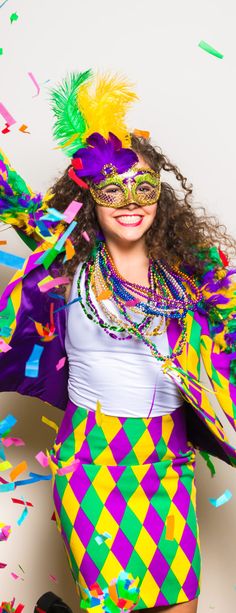 a woman in a mardi gras costume with confetti