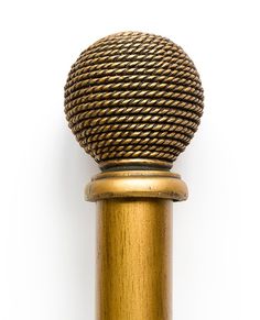 a gold colored pole with a ball on it