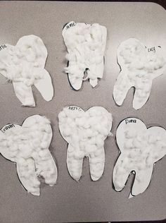 four pieces of toothpaste sitting on top of a metal pan covered in white paper