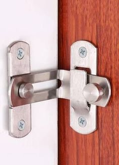 a close up of a door handle on a wooden door