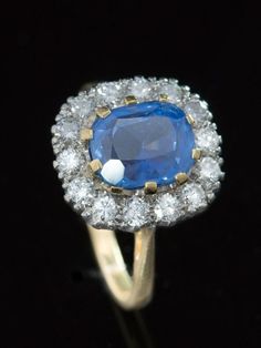 Bewithcing blue Sophisticated elegance and classic style featuring a vibrant, silky cornflower blue natural no heat Ceylon sapphire reminiscent of a celestial sky highlighted by sparkling diamonds.  Dress to impress with this Vintage natural, no heat, Ceylon sapphire and diamond cluster ring.  Heavenly in its totality, this gemstone will mesmerize and entrance. The eye can travel through the stone or pause on the surface or get lost among the refraction and reflections.  Boasting is an evocative Timeless Blue Sapphire Ring With Rose Cut Diamonds, Timeless Blue Diamond Ring With Rose Cut, Timeless Blue Diamond Ring With Rose Cut Diamonds, Heirloom Blue Sapphire Ring With Rose Cut Diamonds, Blue Diamond Ring With Rose Cut Style, Blue Rose Cut Diamond Rings, Formal Blue Rings With Rose Cut Diamonds, Timeless Blue Sapphire Ring Gia Certified, Blue Luxury Diamond Ring With Rose Cut Diamonds