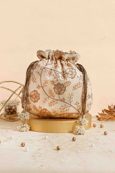 Colour: Cream Embroidered front and back. Dimensions (LxB): 9.5" x 9" (24 cm x 23 cm) Handle drop: 5" (13 cm) Material : Embroidered poly silk, poly satin lining, woven golden thread drawstrings and handle, scallop lace and pearl tassels. Embroidered Pouch For Reception, Zari Work Potli Bag For Festivals And Reception, Festival Reception Potli Bag With Zari Work, Bollywood Style Potli Bag With Dori Work For Reception, Bollywood Style Potli Bag For Diwali Reception, Bollywood Style Potli Bag For Reception On Diwali, Bollywood Style Potli Bag For Reception And Diwali, Bollywood Potli Bag For Reception And Diwali, Festive Embroidered Pouch For Reception