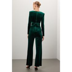 Green velvet (82% viscose, 9% silk, 9% nylon). Jumpsuit. Long sleeves. V-neck. Back zipper closure. 45" from shoulder to hemline. 32" inseam. 12.5" rise. 22" leg opening. Imported. Velvet Jumpsuits And Rompers For Party, Green V-neck Jumpsuits And Rompers For Evening, Chic Velvet Jumpsuits And Rompers, Green Fitted Evening Suit, Chic V-neck Party Suit, Formal Fitted Jumpsuits And Rompers Overall, Formal Fitted Overall Jumpsuits And Rompers, Fitted Full Length Jumpsuits For Evening, Fitted Green Pantsuit For Party