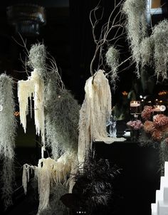 an assortment of artificial plants and trees on display