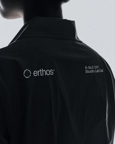 the back of a man's black shirt that says erthos