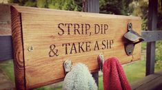 a wooden sign that says strip, dip and take a sip with two stuffed animals hanging on it