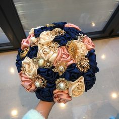 a bridal bouquet is being held by someone's hand