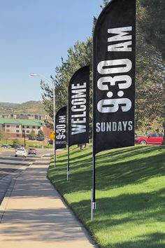 black and white banners on the side of a sidewalk