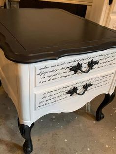 a black and white dresser with writing on it