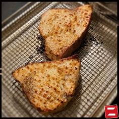 two pieces of toasted bread sitting on top of a cooling rack in front of an oven