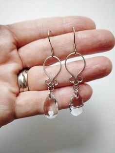 "Simple, yet flattering, wire wrapped earrings with multifaceted teardrop glass beads. Made with 100% stainless steel wire and earring hooks. They hang approximately 1.75\" down from earring hook. Earrings will come on an earring card with plastic earring backs. *Note: this listing is for one pair of earrings. Please choose color below. All my jewelry is handmade, and made with patience, care and love. In the unlikely event that it needs to be repaired, I'll do it free of charge." Wire Wrapped Earrings Simple, Modern Glass Teardrop Earrings, Silver Wire-wrapped Teardrop Earrings, Modern Dangle Crystal Earrings With Ear Wire, Everyday Nickel-free Teardrop Wrap Earrings, Silver Teardrop Wrap Earrings, Elegant Teardrop Wrap Earrings Nickel-free, Elegant Teardrop Wrap Earrings Nickel Free, Elegant Teardrop Nickel-free Wrap Earrings