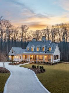 a large white house with lots of windows on it's roof and walkway leading to the front door