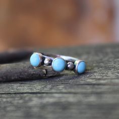 "🌟PLEASE READ the following description before making your purchase.  Note measurements and size reference photos. Three stone blue Kingman turquoise sterling silver ring Three 5mm American mined blue Kingman turquoise stones are set in pure silver with 3mm pure silver pebble accents supported by an 4mm (1/8\")  sterling silver band." Stackable Blue Turquoise Ring In Sterling Silver, Turquoise Blue Sterling Silver Toe Ring, Dainty Blue Turquoise Stackable Ring, Pebble Ring, Sterling Silver Rings Turquoise, Ring Turquoise, Jewelry Sale, Turquoise Stones, Kingman Turquoise