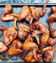 chicken wings on a baking sheet ready to be cooked in the oven for roasting