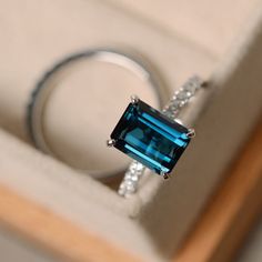 This ring features a 7*9mm emerald cut London blue topaz and sterling silver finished with rhodium. Customization is available. It is made by hand, and it will take about 7 days to finish the ring after your payment is completed. Main stone: London blue topaz London blue topaz weight: Approx 3.15 ct Metal type: sterling silver finished with rhodium Accent stone: cz Customization is available, I also can make it with 14k solid gold (white or yellow or rose) and diamond accent stone, just feel fre London Blue Topaz Engagement Rings, November Birthstone Ring, Blue Topaz Engagement Ring, Topaz Engagement Ring, London Blue Topaz Ring, November Birthstone, Silver Engagement Rings, Ring Blue, Emerald Engagement Ring