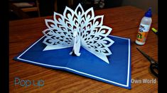 a paper cut out of a flower sitting on top of a table