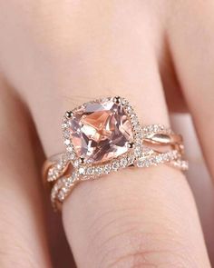 a woman's hand with an engagement ring on it