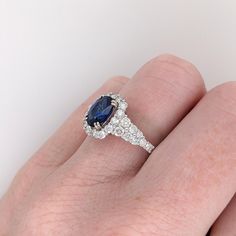 This ring design is a tried and tested NNJ Designs favorite! Featuring a gorgeous Ceylon blue sapphire with a stunning diamond halo and accented shank that elevates this ring to a gorgeous statement piece, all set in solid 14k gold! This ring is made with solid 14K Gold and naturally Earth-mined SI / G-H diamonds. As listed, this ring is ready to ship. If you're interested in purchasing this setting with a different center stone please message us! Gia Certified Blue Diamond Halo Ring, Blue Gia Certified Diamond Halo Ring, Blue Sapphire Halo Ring With Round Cut, Blue Lab-created Sapphire Halo Ring With Prong Setting, Blue Sapphire Ring With Halo Diamond Design, Blue Diamond Ring With Halo Design, Blue Sapphire Ring With Diamond Halo Design, Blue Sapphire Ring With Halo Design, Round Cut, Blue Halo Ring With Brilliant Cut