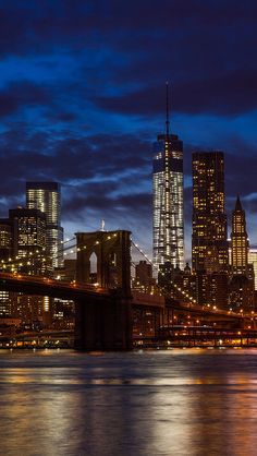 the city skyline is lit up at night