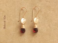 >> These are natural garnet teardrops wire wrapped by hand with 14kt Gold filled wire. >> They sway from a gold electroplated brushed disc. >> Earrings hang from my signature French ear wires, also made with 14kt gold fill wire. >> The wire ends have been smoothly filed for comfort. >> Pair includes clear rubber backs (not shown on pics) optional to wear. >> Lightweight earrings. >> LENGTH: From top of ear wire to bottom of drop measures approx. 1 -1/2" (38 mm) long.  >> Garnet teardrops are 7 mm wide; gold discs are 8 mm wide. >> Great birthday gift for mom, Anniversary gift, or Valentine's day gift. >> Garnet is January birthstone. >>You will receive the exact item shown in this listing. >>Hand made at my home studio in Colorado Springs, Colorado. Snow, rain or shine! >>PERSONALIZED NOTE Wine Gold Earrings, Gold Circle Earrings, Snow Rain, Garnet And Gold, Artisan Earrings, Disc Earrings, Gold Circle, January Birthstone, Earrings Red