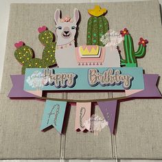 a happy birthday banner with llamas and cacti