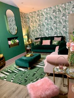 a living room with green walls and pink furniture in the center, palm leaves on the wall