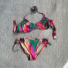 Madewell Electric Ikat Bikini Set. Madewell J.Crew Colorful Bikini Set. Underwire Halter Bikini Top With Side Tie Bikini Bottoms. Stunning Bow Detailing On The Bikini Bottoms. Stripe Bikini Set. Brown, Blue, Green, Orange, Purple, Magenta Color. Bustier Bikini Top. Balconette Bikini Top. Underwire Bikini. Halter Top Bikini. Side Tie Bikini Bottoms. Perfect Condition. Bikini Top Is A Size 36 B Bikini Bottoms Are A Size Small 84% Nylon 16% Spandex. #Bikini #Swim #Bows #Stripes #Retro Adjustable Multicolor Swimwear For Sunbathing, Adjustable Multicolor Tie-side Swimwear Bottom, Adjustable Multicolor Tie-side Swimwear, Multicolor Adjustable Swimwear For Poolside, Adjustable Multicolor Swimwear For Poolside, Adjustable Tropical Multicolor Swimwear, Multicolor Halter Neck Tankini For Sunbathing, Multicolor Stretch Tankini With Tie-side Bottom, Adjustable Multicolor Beachy Swimwear