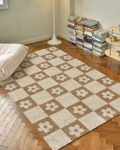 a white and brown rug sitting on top of a wooden floor next to a lamp