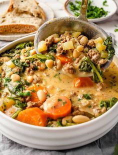 a white bowl filled with soup and vegetables