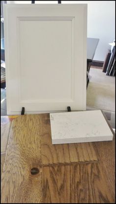 a white frame sitting on top of a wooden floor