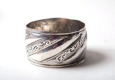 A fine, weighty  high grade silver bracelet from the Anti Atlas region in Morocco. Height 4 cms, diameter 6.5 cms Weight 93 grams Would fit over a medium to large hand. Beautifully worn. It was once a lady's dowry or savings. Silver Engraved Wide Band Bangle, Traditional Silver Wide Band Jewelry, Silver Work, Cuff Bangles, Silver Bangles, Arm Band, Cuff Bracelet, Bangle Bracelets, Silver Bracelet