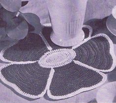 a crocheted flower pot holder on a table