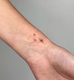 a small star tattoo on the left inner arm is shown in black ink, and has five stars drawn across it