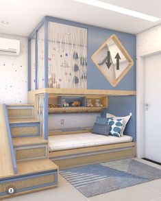 a bedroom with blue walls and stairs leading up to the loft bed, which also has a built - in bookcase