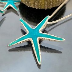 A Sterling silver pendant. ✴A cute blue starfish for a pendant. Α summer necklace. A five stars-reviewed item! 📜A Starfish sterling silver necklace in a sea blue background, rubber,       cotton cord, or  Silver chain with a secure clasp.      You can wear it everywhere, day and night, or make it a gift to       someone who loves to wear it.      Buying more than one piece you get a better price!      Please message me! 📐  25mm width. ✍. Designed and created by. Babuco Jewellery Athens.  A Gre Turquoise Starfish Ocean-inspired Jewelry, Turquoise Ocean-inspired Jewelry With Starfish Charm, Ocean-inspired Turquoise Necklace With Starfish Charm, Turquoise Ocean-inspired Necklace With Starfish Charm, Turquoise Necklace With Starfish Charm, Turquoise Jewelry With Starfish Charm For Gift, Turquoise Jewelry With Starfish Charm As Gift, Blue Starfish Charm Necklace, Handmade Turquoise Starfish Jewelry