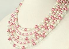 This beautiful 5 strand statement necklace is delicate, classy and stunning! Deep rose glass pearls are strung alongside cream glass pearls and clear sparkling crystals to make a great timeless piece that you can wear again and again. Dress it up, dress it down, it is the staple piece your jewelry collection is missing! :)Measurements: Approximately 18 inches long at the shortest strand and 24 inches long at the longest strand with a 3 inch chain extender for easy length adjustment. Please messa Multi-strand Pearl Beaded Necklace For Wedding, Wedding Multi-strand Pearl Beaded Necklace, Multi-strand Beaded Necklaces With Pearl Drop For Weddings, Beaded Multi-strand Pearl Necklace For Wedding, Multi-strand Beaded Necklace With Pearl Drop For Wedding, Multi-strand Pearl Drop Beaded Necklaces For Weddings, Wedding Multi-strand Beaded Necklaces With Pearl Drop, Wedding Multi-strand Beaded Necklace With Pearl Drop, Feminine Beaded Necklaces For Wedding