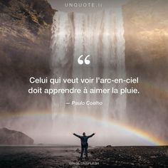 a man standing in front of a waterfall with his arms wide open and a rainbow behind him