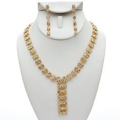 This jewelry set is stunning! It is encrusted with clear, sparkling rhinestones and cream pearls along a gold plate. It is perfect for weddings, proms, formals, parties, pageants, and more. It coordinates with any color or style wedding dress or formal ensemble. Elegant Gold Rhinestone Necklace For Formal Occasions, Elegant Gold Crystal Rhinestone Necklace, White Gold Plated Jewelry Sets For Party, Glamorous Gold Cubic Zirconia Bridal Necklace, Gold Cubic Zirconia Bridal Necklace For Party, Gold Bridal Necklace With Cubic Zirconia For Party, Glamorous Gold Bridal Necklace With Cubic Zirconia, Glamorous Gold Jewelry Sets For Party, Dazzling Gold Rhinestone Necklace For Formal Occasions